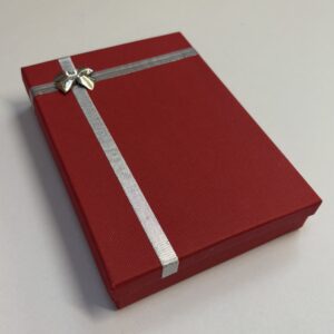 Red cardboard Collarette box with silver bow and ribbon on the lid. 136 x 188 x 35mm